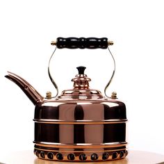 a tea kettle sitting on top of a wooden table