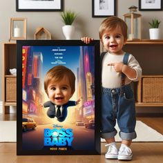 a little boy holding up a framed poster with the character boss baby on it's face