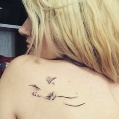 a woman with a bird tattoo on her shoulder