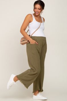 A pair of crop length, linen maternity pants featuring an elastic waistband, side pockets, and fringe trim. The Olive Linen Frayed Hem Crop Maternity Pants is perfectly bump-friendly! Linen Pants Outfit Pregnant, Linen Pregnancy Outfit, Linen Maternity Pants, Linen Pants Maternity Outfit, Linen Pants Pregnancy Outfit, Maternity Wide Leg Pants Outfit, Comfy Pregnancy Outfits Summer, Olive Linen Pants Outfit, Stylish Maternity Outfits Summer