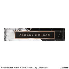 marble name plate with black and white marble pattern on the front, gold trimming around the edges