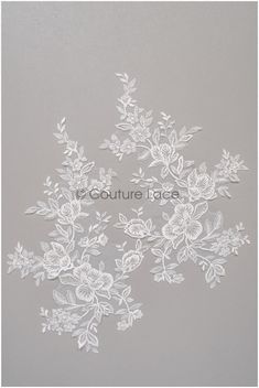 white lace with flowers and leaves is shown on a gray background, as well as the words couture lace