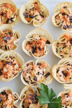 small appetizers are arranged on a white platter