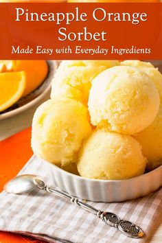 pineapple orange sorbet made with everyday ingredients in a white bowl on an orange tablecloth