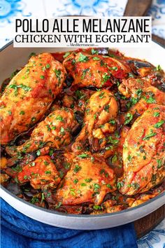 chicken with eggplant in a skillet on a blue and white table cloth