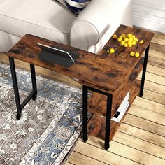 a table with some fruit on it in the middle of a living room next to a couch