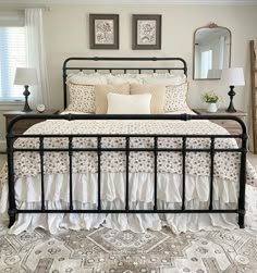 a bed with white sheets and pillows in a bedroom