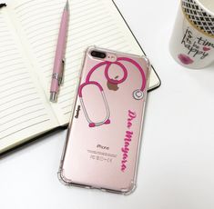 a pink phone case with a stethoscope on it next to a cup of coffee