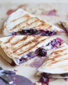 two quesadillas cut in half on a cutting board