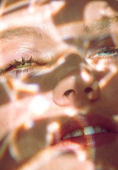 a woman's eyes are reflected in the sunlight