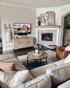 a living room filled with furniture and a flat screen tv mounted on the wall above a fire place