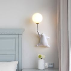 there is a white cat on the wall with a light