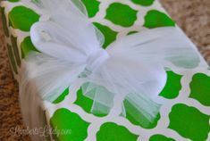 a present wrapped in green and white paper