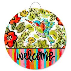 a colorful welcome sign with a hummingbird on it