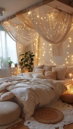 a bedroom with lights on the walls and a bed covered in white sheets, pillows and blankets