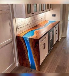 a kitchen counter that has been painted to look like a river running through the center of it