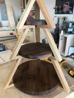 a three tiered wooden shelf in a workshop