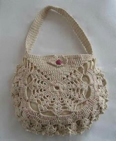 a crocheted purse sitting on top of a white table