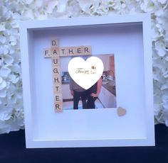 a photo frame with scrabbles in the shape of a heart