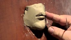 someone is making a clay mask out of clay