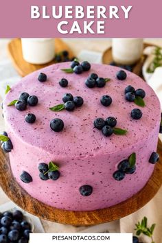 a blueberry cake on a wooden platter with the words, how to make a blueberry cake