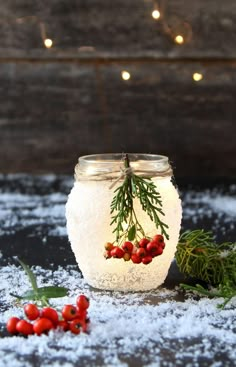 a mason jar filled with snow and berries