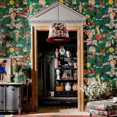 a living room filled with furniture and colorful wallpaper