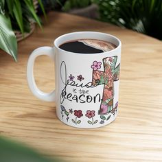 a coffee mug with the words jesus is the reason on it sitting on a table