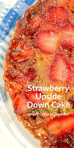 a close up of a cake on a plate with strawberries in the middle and text overlay that reads strawberry upside down cake