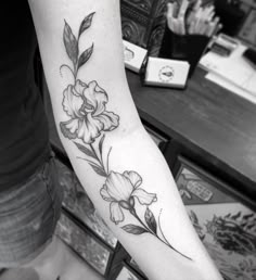 a black and white photo of a flower on the arm