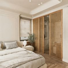 a large bed sitting next to a wooden closet in a bedroom on top of a hard wood floor