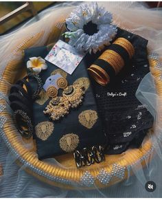 a basket filled with lots of different types of jewelry on top of a white table