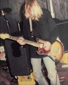 a man playing an electric guitar on stage