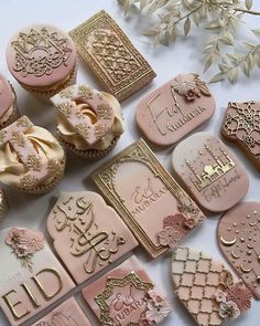 some pink and gold decorated cookies on a table