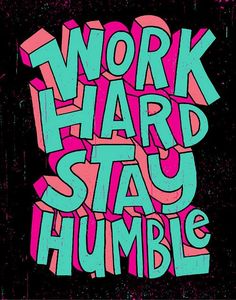 the words work hard stay humbie are painted in pink and blue on a black background