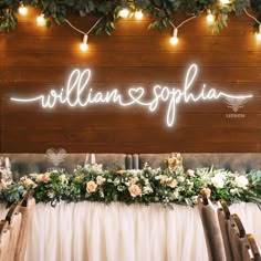 a sign that says williams & sophan on it with flowers and greenery