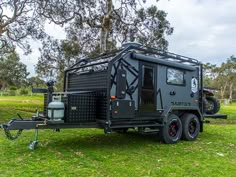 an off road camper trailer parked in the grass