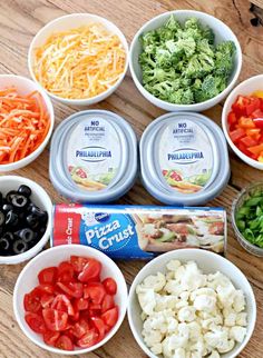 six bowls filled with different types of food on top of a wooden table next to an empty can