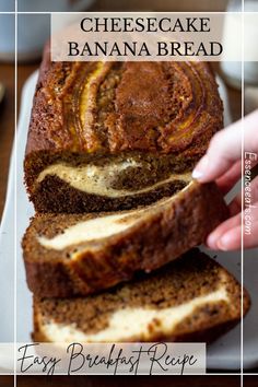 a person is cutting into a loaf of bread on a white platter next to a cup of coffee