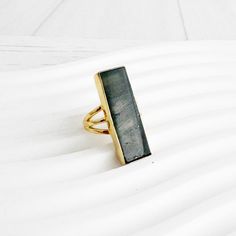 "Large Labradorite Rectangle Bar Statement Ring in Gold and Silver. Crystal Stone Cocktail Ring. Gold Silver Gemstone Ring The definition of a wear-anywhere statement. This ring features a large rectangular stone and a simple band design that add the finishing touch to any look. GEMSTONE: Labradorite STONE SIZE: 1.15\" long RING SIZE: Adjustable MATERIAL: Gold/Silver plated brass Find more unique statement rings here - https://www.etsy.com/shop/RusticGem?section_id=45302653 Questions?  Please don't hesitate to start a convo, we'd love to hear from you! WELCOME! Welcome to Rustic Gem Jewelry! Thank you for visiting our shop. We take custom orders and can often do a similar piece in different colors. We also offer bulk / bridal discounts. If you have any questions regarding this item, please Rectangular Gemstone Ring For Everyday, Minimalist Stackable Rings With Rectangular Stone, Ring Rectangle, Long Ring, Simple Band, Gold Cocktail Ring, Band Design, Gem Ring, Statement Ring Silver