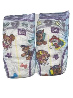 two cloth diapers with dogs on them, one is white and the other has purple trim