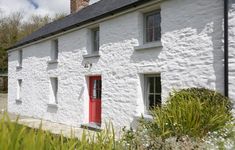 a white house with red door and windows