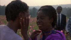 two women are talking to each other in a field