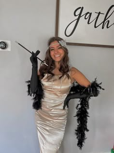 a woman in a dress and feathered gloves poses for the camera while holding an umbrella