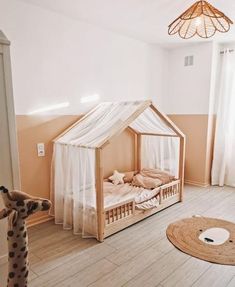 a child's room with a bed, stuffed animal and other items on the floor