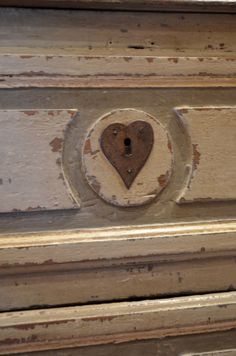 an old drawer with a heart shaped lock on it