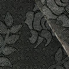 black and white polka dot print fabric with silver dots on the bottom, as well as an