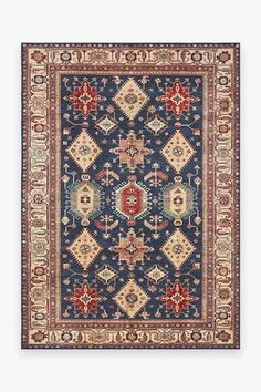 a blue rug with red, yellow and white designs on the center is an ornate border