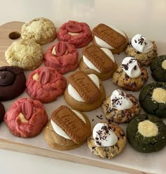 an assortment of cookies and pastries on a cutting board