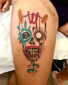 a man's leg with a colorful skull tattoo on it